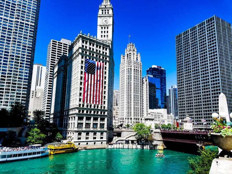 Chicago, Illinois, USA. 07 06 2018. Wrigley building with large american flag on 4th July week. River watefront.