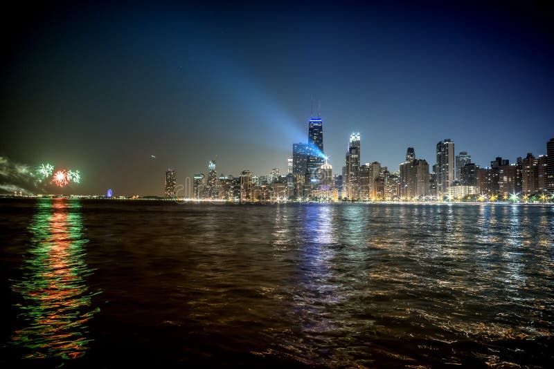 Chicago skyline with a light beam and fireworks at night stock photography Chicago skyline with a light beam and fireworks at night stock photography