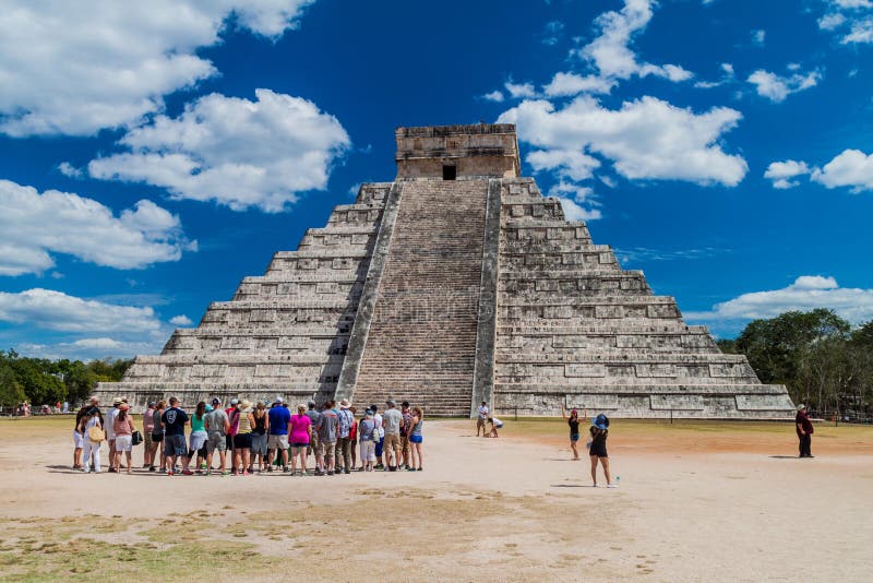 CHICHEN ITZA, MEXICO - FEB 26, 2016: Crowds of tourists visit the Kukulkan pyramid at the archeological site Chichen Itz royalty free stock image
