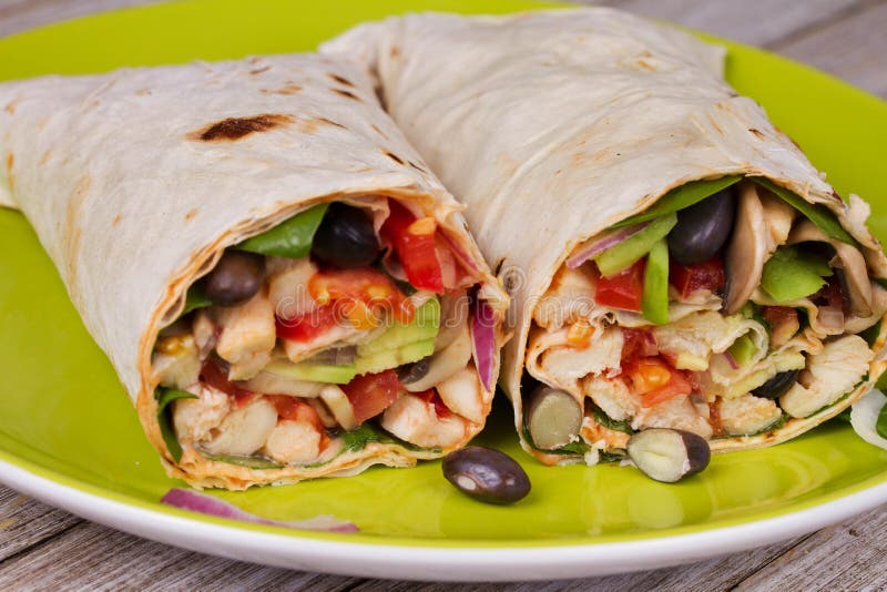 Chicken, Avocado, and Black Beans Burrito in Green Plate Stock Image