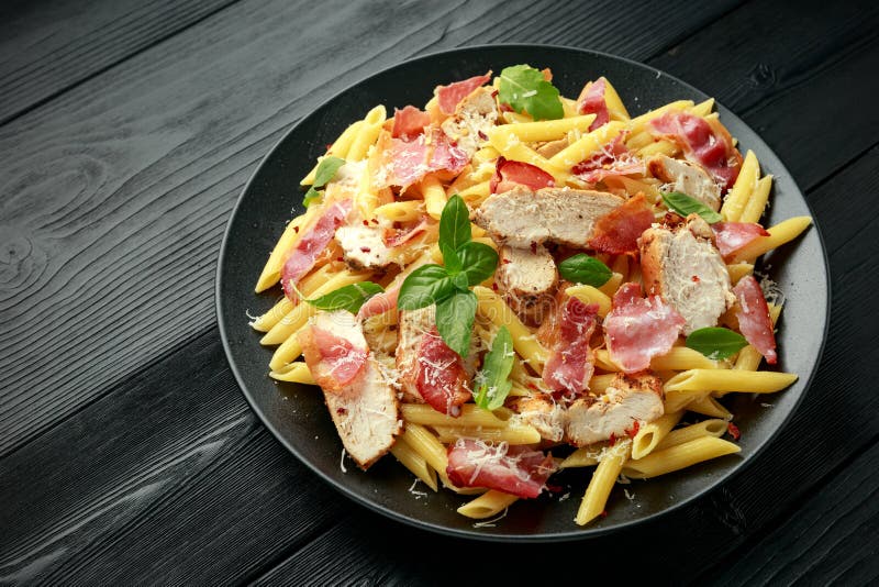 Chicken, Bacon Penne Pasta with Parmesan Cheese and Basil. Healthy Food