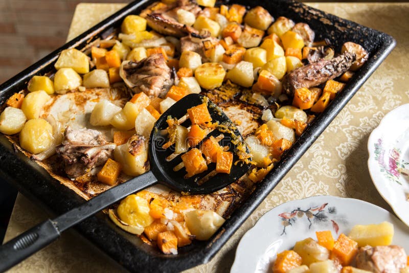 Chicken baked with potato and a pumpkin