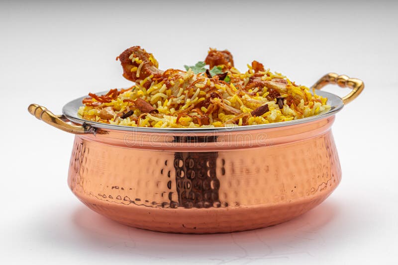 Chicken biryani , kerala style chicken dhum biriyani made using jeera rice and spices arranged in a brass serving bowl with white background, isolated. Chicken dum biryani stock images, royalty-free photos and pictures