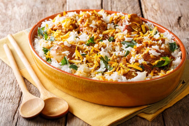 Chicken biryani with spicy spices, orange peel and cilantro close-up in a bowl on the table. horizontal. Chicken dum biryani stock images, royalty-free photos and pictures