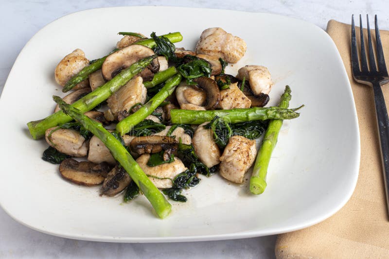 Chicken Bites with Spinach, Asparagus and Mushrooms Stock Photo - Image