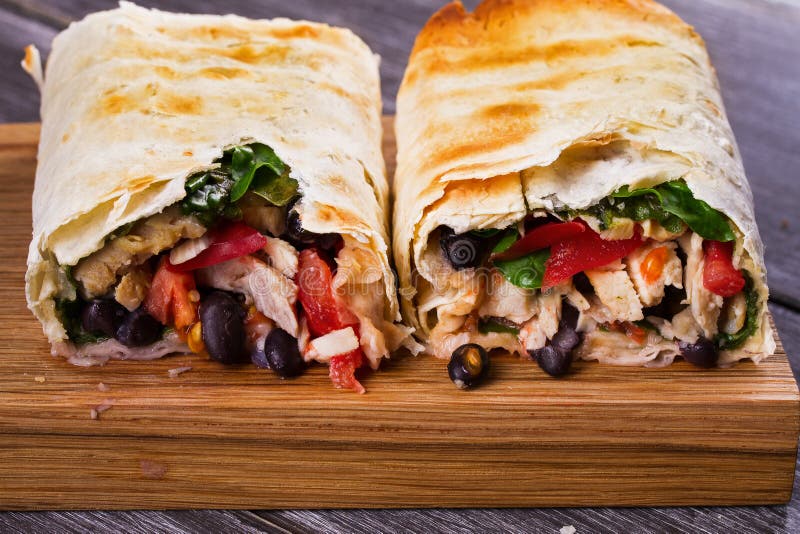 Chicken, Black Beans, Spinach and Tomato Burritos. Stock Photo Image