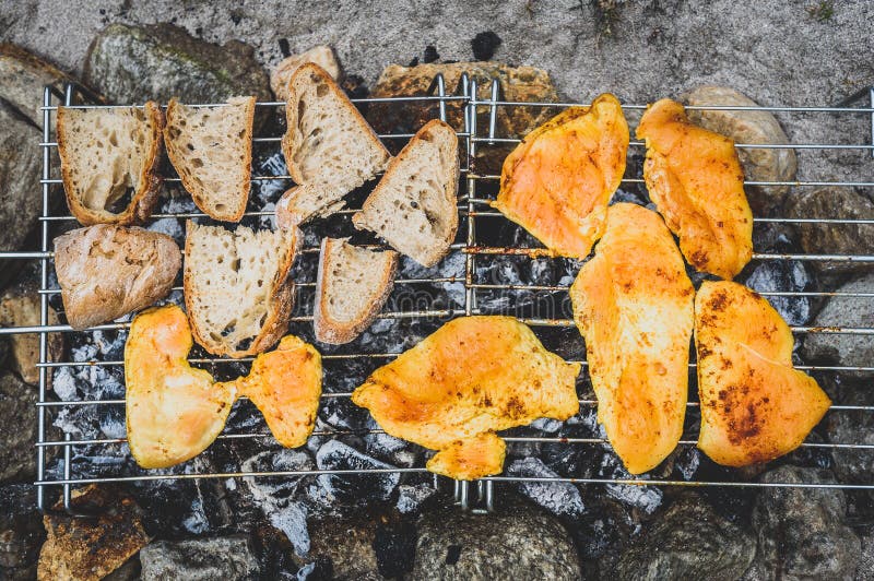 Chicken and bread on homemade improvised BBQ barbecue grill. royalty free stock image Chicken and bread on homemade improvised BBQ barbecue grill. royalty free stock image