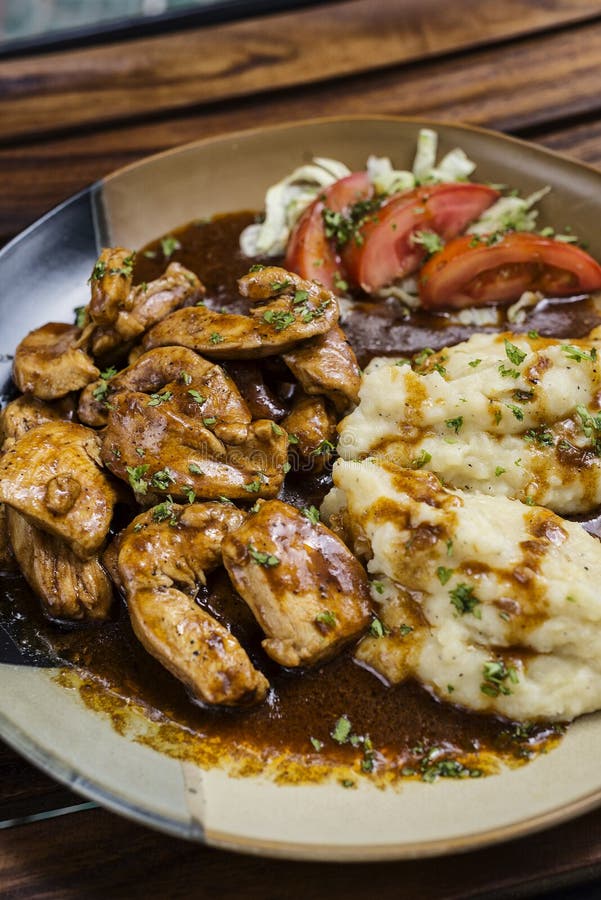Chicken Breast with Brown Gravy Sauce and Mashed Potato Stock Image