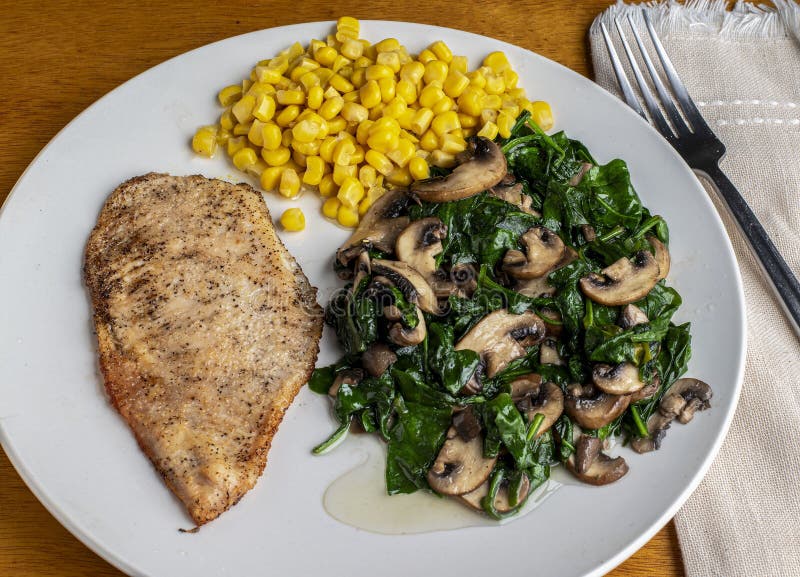 Chicken Breast Served with Sauteed Spinach and Mushrooms Stock Photo
