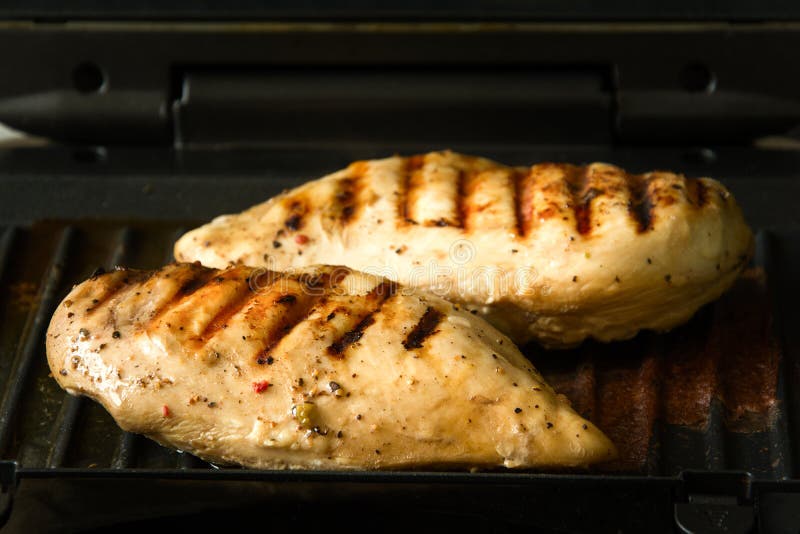 Chicken breasts on a grill stock photo. Image of cooking 99754352