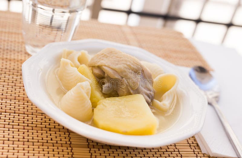 Chicken Broth Soup with Chicken, Potatoes, and Pasta Shells Stock Image