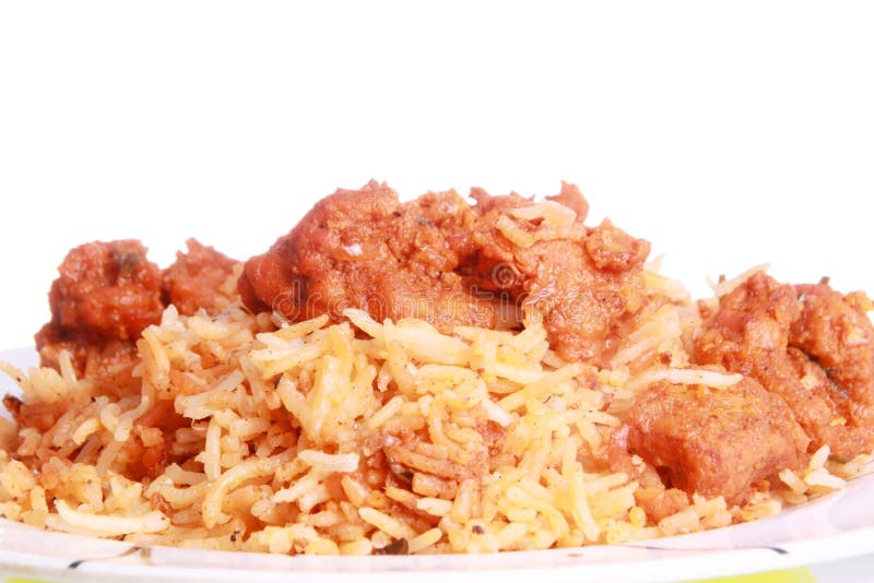 Spicy boneless chicken curry is served over chicken biryani and photographed against white background. Chicken dum biryani stock images, royalty-free photos and pictures