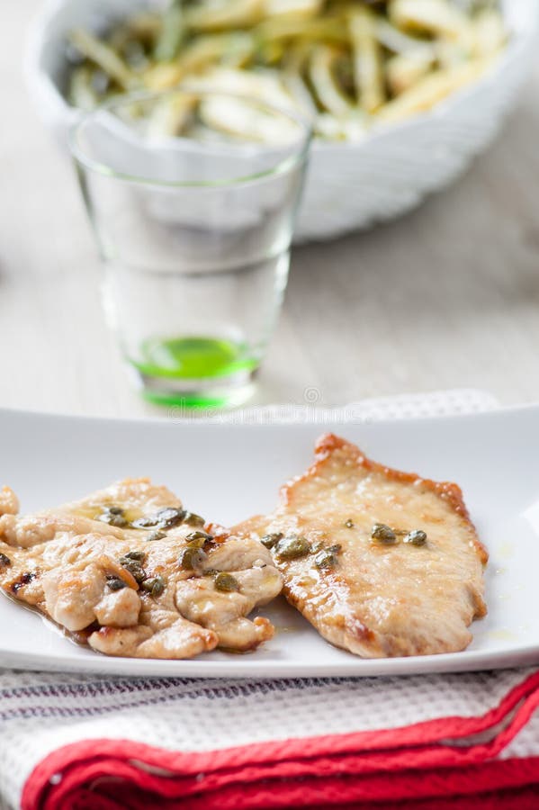 Chicken Cutlet with Lemon and Capers Stock Image Image of plate