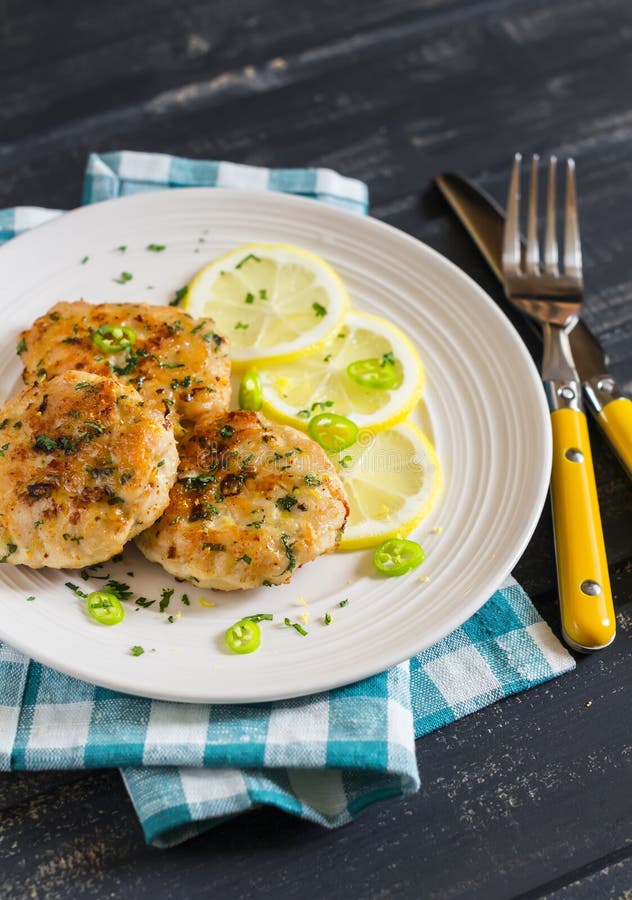 Chicken Cutlets With Lemon And Herbs On A White Plate Stock Image ...