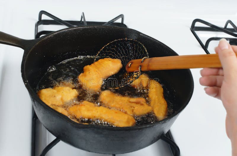 Chicken Deep Frying In Hot Oil In A Cast Iron Frying Pan Stock Photo,  Picture and Royalty Free Image. Image 17721959.