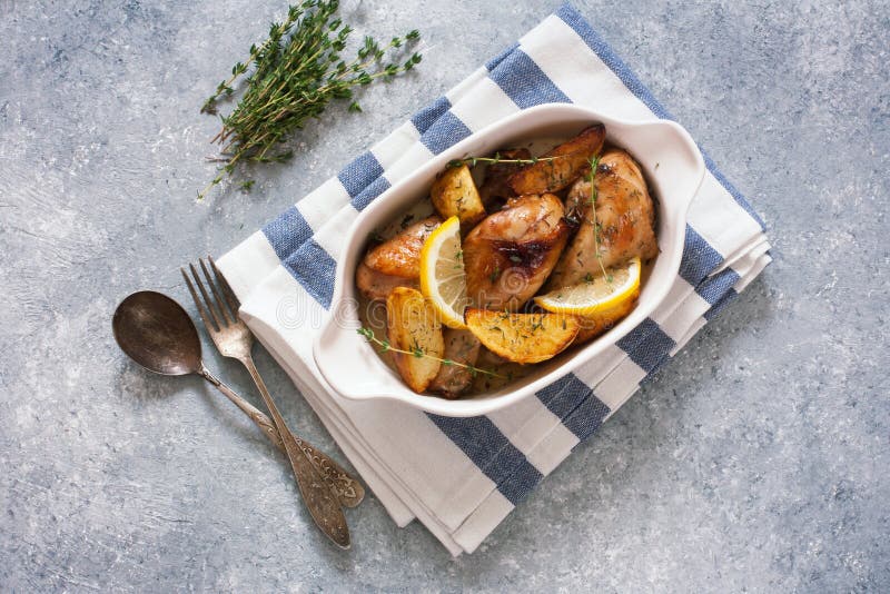 Chicken Drumsticks Baked with Potatoes , Lemon and Herbs Stock Photo Image of meal, rustic