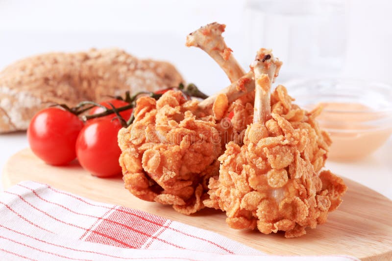 Chicken drumsticks coated with corn flakes