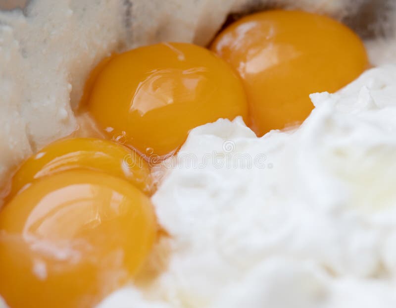 Chicken Egg Yolks on the Background of White Protein Mass Stock Photo