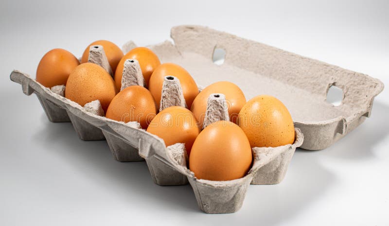 Chicken eggs in a box, on a white background