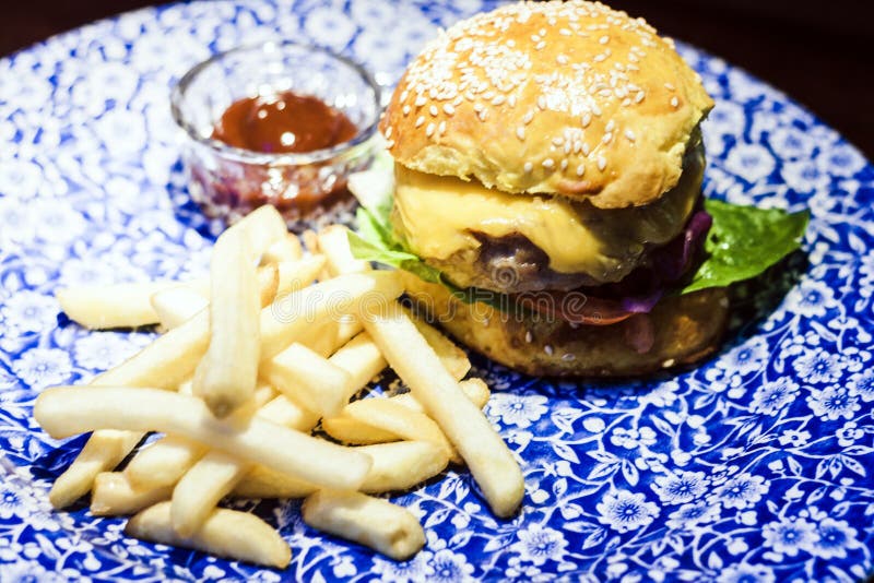 Chicken Hamburger, Fries and Sauce on the Blue Plate in Restaurant