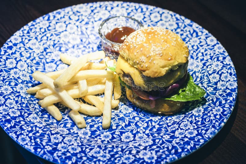 Chicken Hamburger, Fries and Sauce on the Blue Plate in Restaurant