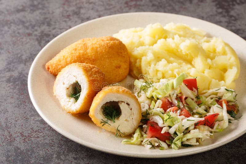 Chicken Kiev Cutlets Served with Salad and Mashed Potatoes Closeup in