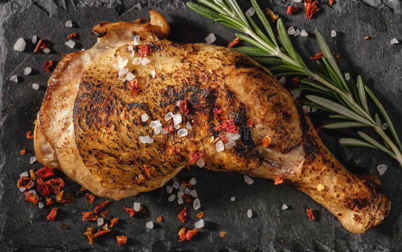 Chicken leg roasted over black background. View from above royalty free stock images Chicken leg roasted over black background. View from above royalty free stock images