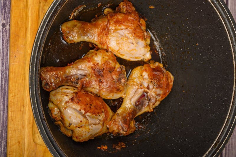 Chicken Legs Marinated with Spices are Fried in a Cauldron Stock Image