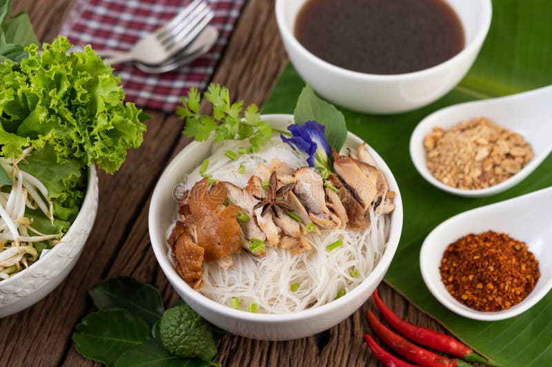Chicken Noodle in a Bowl with Side Dishes, Thai Food Stock Photo