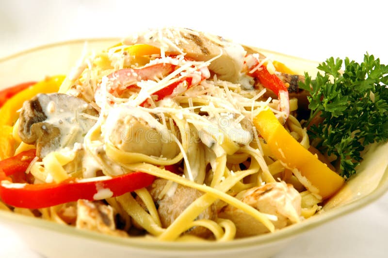 Fettucine pasta with peppers, mushrooms, and chicken in a rich cream sauce. Fettucine pasta with peppers, mushrooms, and chicken in a rich cream sauce.