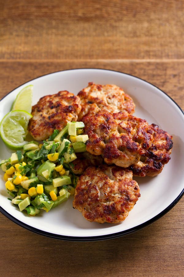 Chicken Patties or Burgers with Avocado Corn Salsa. Stock Photo Image