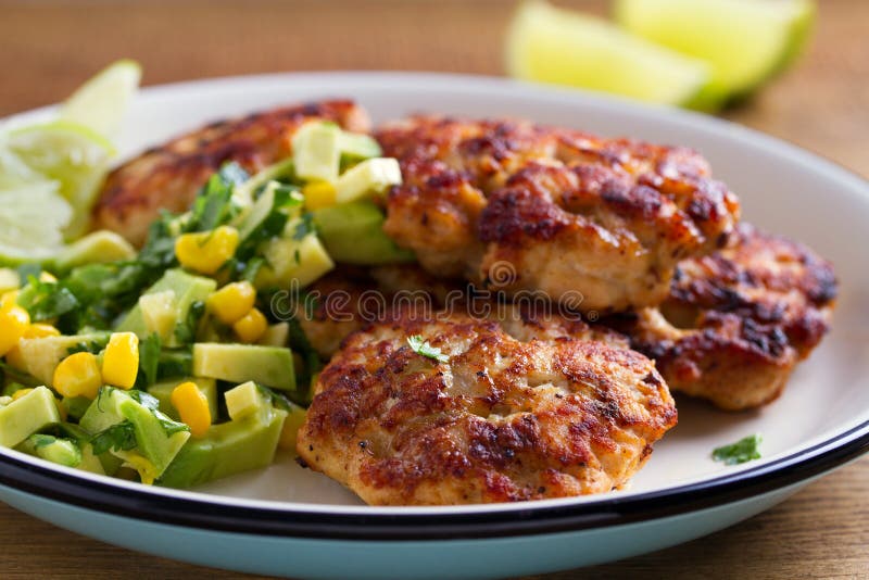 Chicken Patties or Burgers with Avocado Corn Salsa. Stock Photo Image