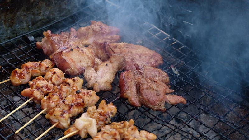 Chicken and pork grill over the small flame. 4K, UHD.