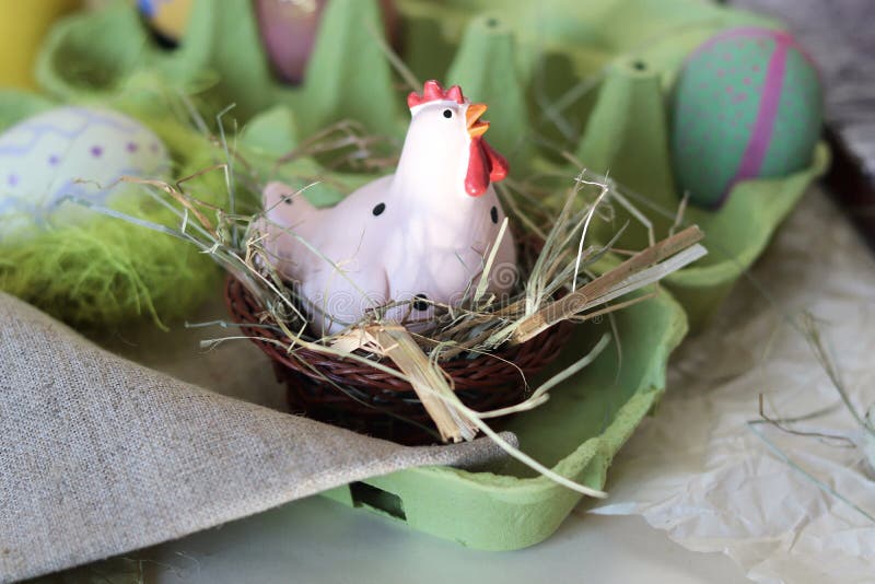 Toy Chicken, Eggs, Hay, Easter Decor on a Light Background Stock Image