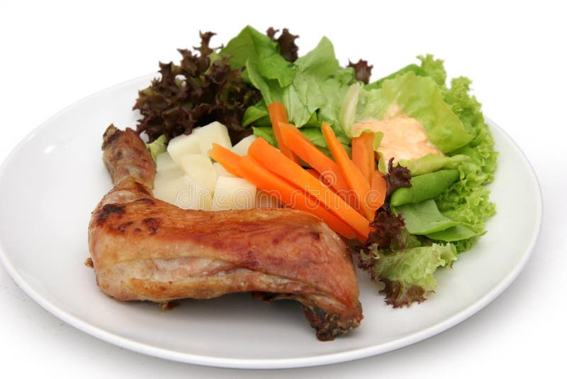 Roasted leg of chicken with potato salad, capsicum slices and cherry tomatoes. Crispy diet stock images, royalty-free photos and pictures