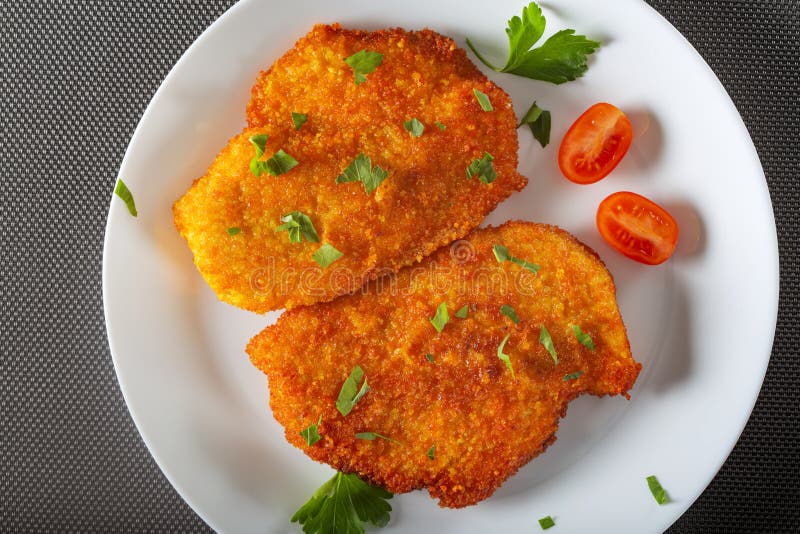 Chicken schnitzel on plate stock photo. Image of breaded 173876836