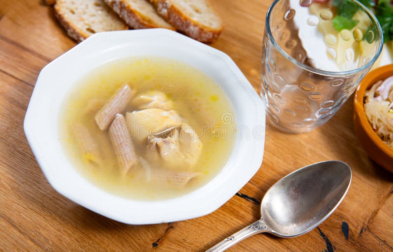 Chicken soup with pasta served in bowl stock images