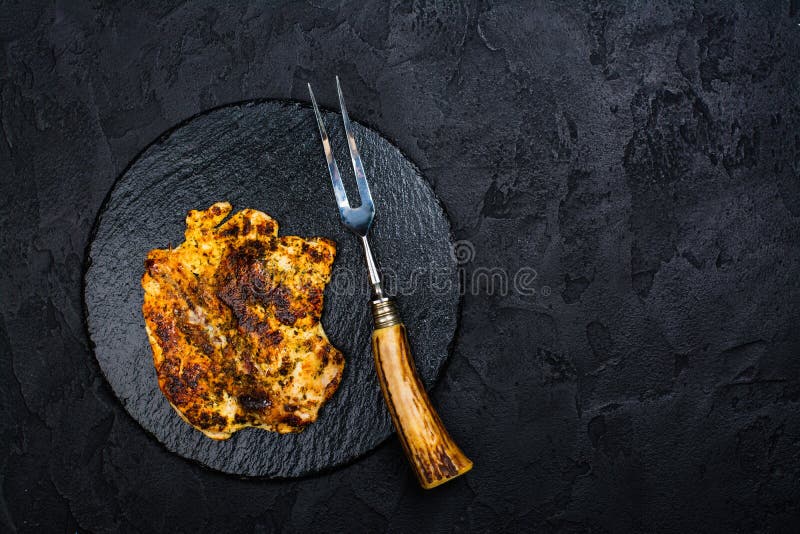 Chicken steak on slate board stock image Chicken steak on slate board stock image
