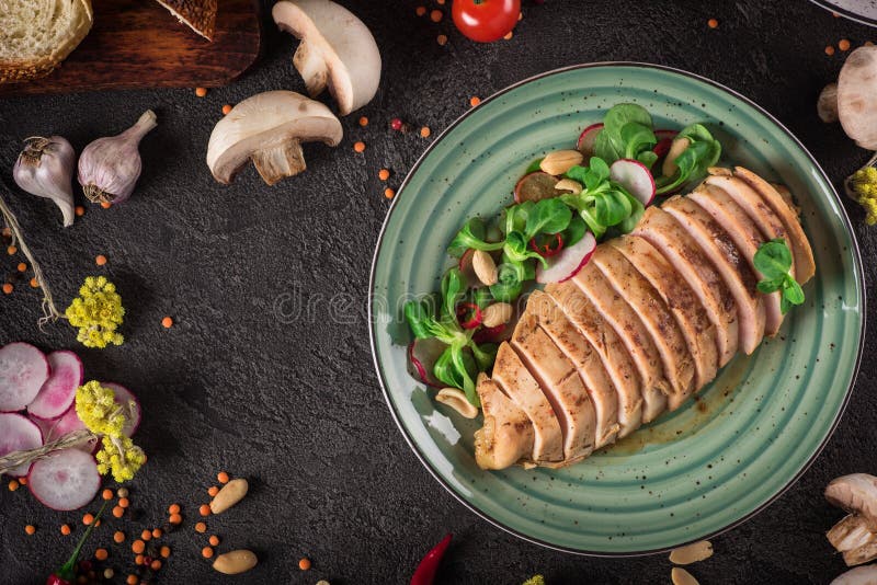 Chicken steak roasted and salad, food photography. Black background. Top view stock images Chicken steak roasted and salad, food photography. Black background. Top view stock images