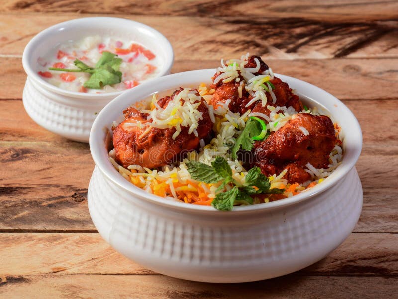 Chicken Tikka Biryani made of Basmati rice cooked with masala spices, served with yogurt, selective focus. Chicken dum biryani stock images, royalty-free photos and pictures