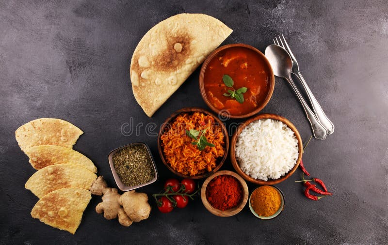 Chicken tikka masala spicy curry meat food in pot with rice and naan bread. indian food with chicken and curry. Chicken tikka masala spicy curry meat food in pot with rice and naan bread. indian food with chicken and curry