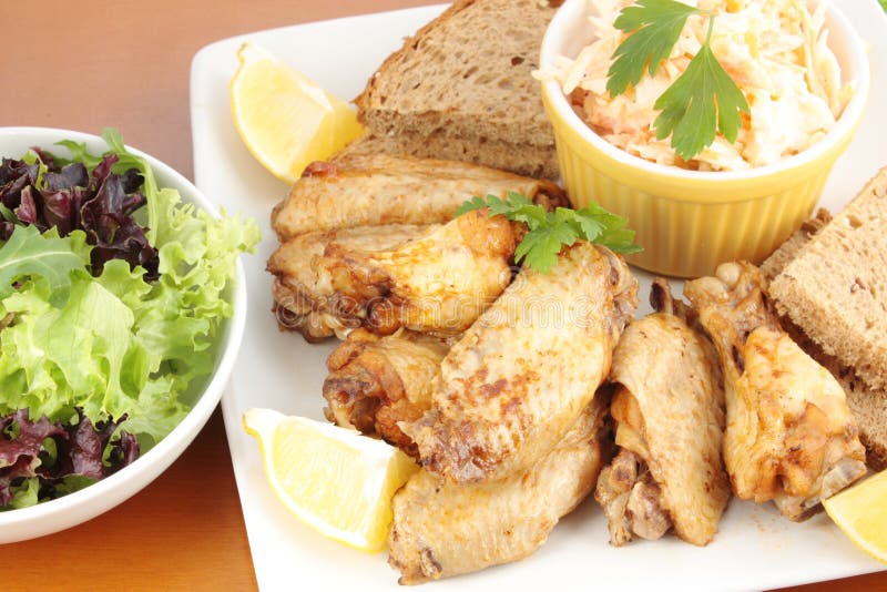 Chicken Wings, Coleslaw and a Side Salad Stock Photo Image of