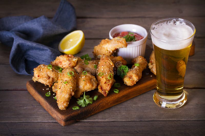 Chicken Wings on Serving Board and Glass of Beer. Stock Image Image