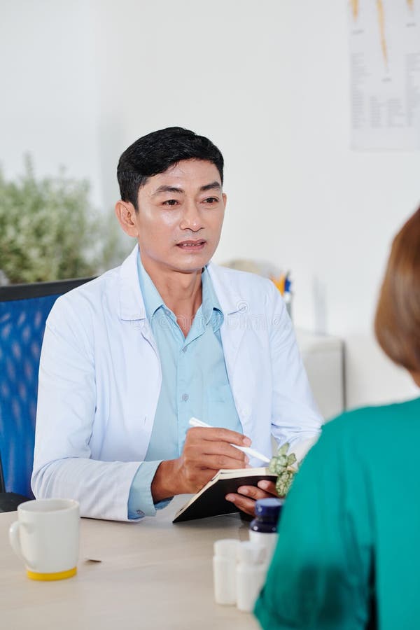 Chief physician talking to colleague royalty free stock images