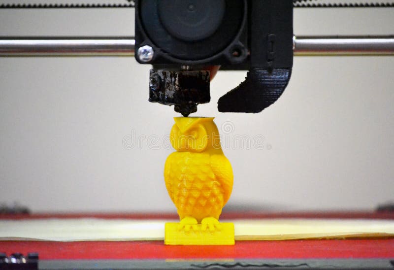 Modern 3D printer printing figure close-up. Automatic three dimensional 3d printer performs plastic yellow colors modeling in laboratory. Progressive modern additive technology. Modern 3D printer printing figure close-up. Automatic three dimensional 3d printer performs plastic yellow colors modeling in laboratory. Progressive modern additive technology