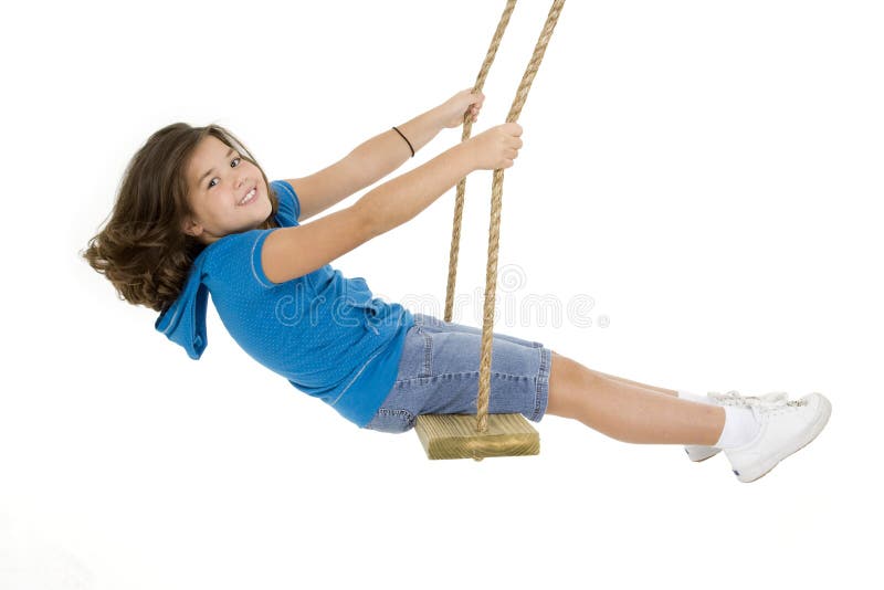 Cute Caucasian child playing on a wooden swing