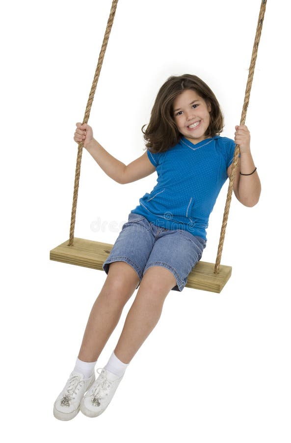 Cute Caucasian child playing on a wooden swing