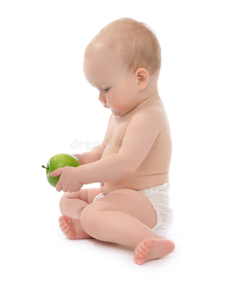 Child baby girl toddler sitting eating green apple