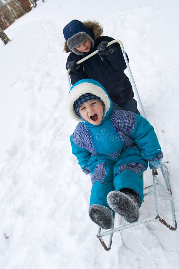 Child and baby on sled