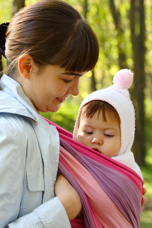 Child in a baby sling. stock photo. Image of holding 16680608